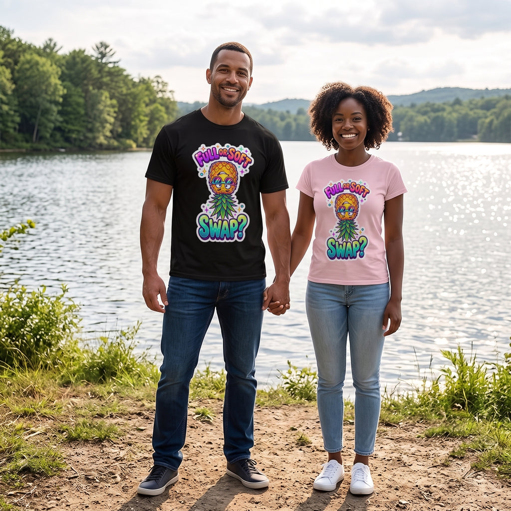 A man and a woman standing on a lakeshore holding hands, wearing matching graphic t-shirts. The man wears a black t-shirt and the woman wears a light pink t-shirt, both featuring a colorful cartoon graphic of a tree with the text 'POOH-ASS SWAP?'.