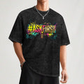 Man standing with a weathered black & gray shirt with #ASKFIRST in bright colors on the front with a silver chain around his neck.