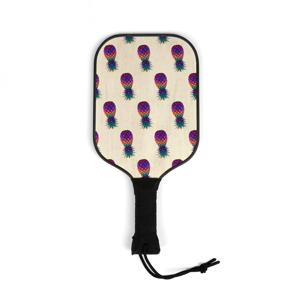 Wooden pickleball paddles featuring vibrant pineapple-inspired artwork printed on both sides.