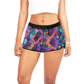 Woman wearing  a white crop top and swinger lifestyle colorful shorts with black trim.