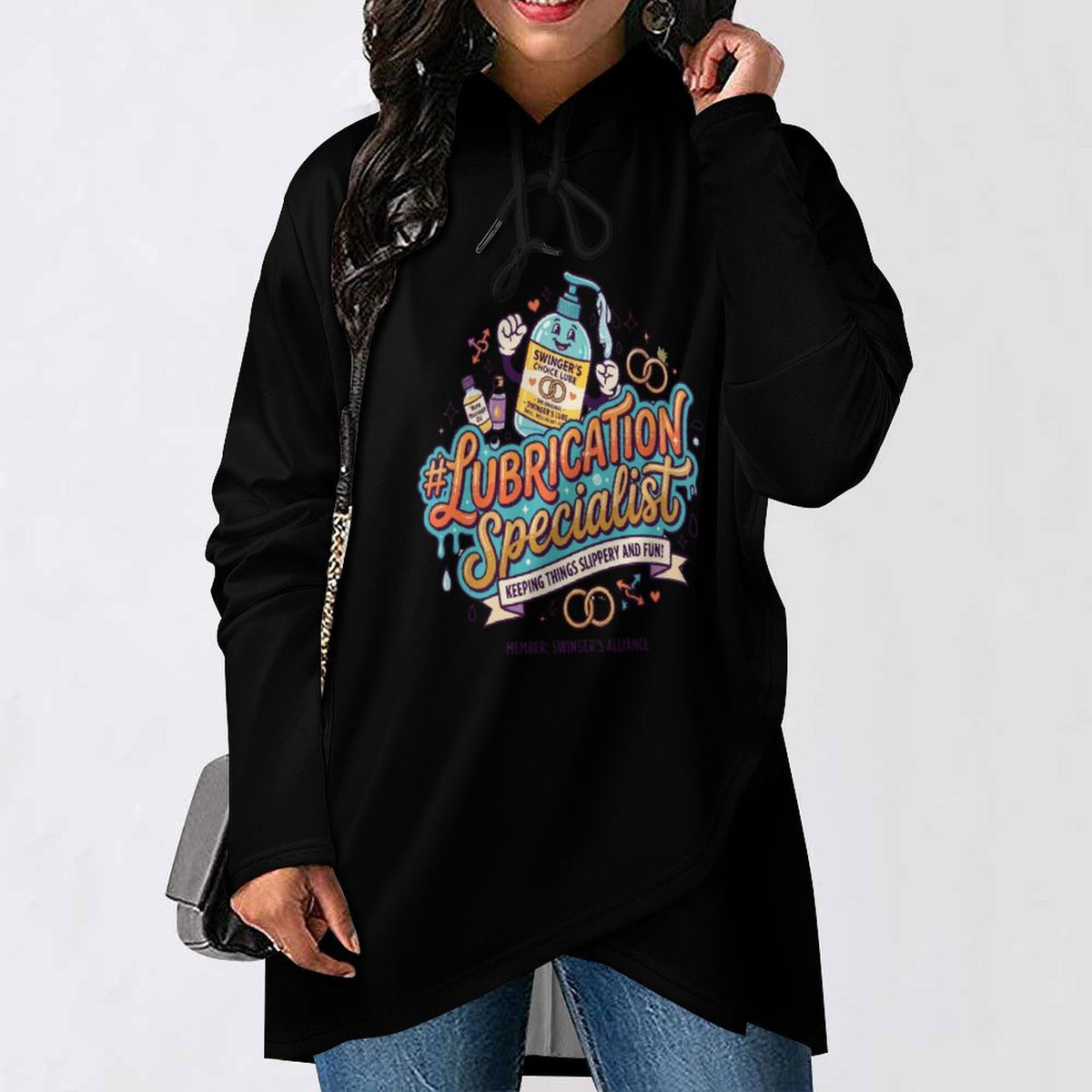 A woman wearing a black oversized hoodie with a colorful graphic that reads '#Lubrication Specialist' and 'Every Time Support You' with a bottle illustration, paired with blue jeans against a plain white background.