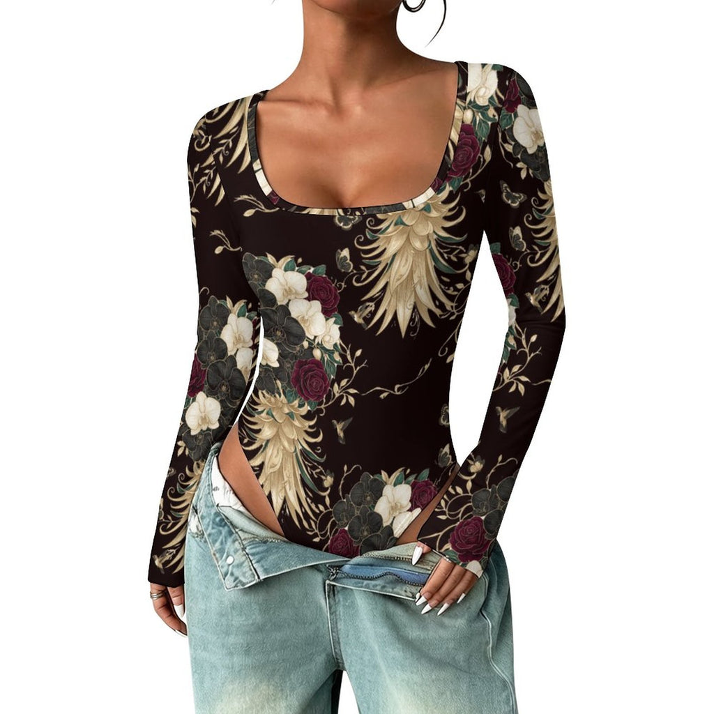 A woman wearing a long-sleeve scoop-neck bodysuit with a dark brown background and a detailed print of white, burgundy, and gold phoenixes and flowers, paired with light-wash blue jeans.
