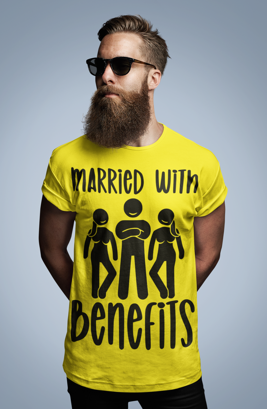 A man with a beard and sunglasses wearing a yellow crew neck t-shirt with the text 'MARRIED WITH BENEFITS' and an illustration of two people.