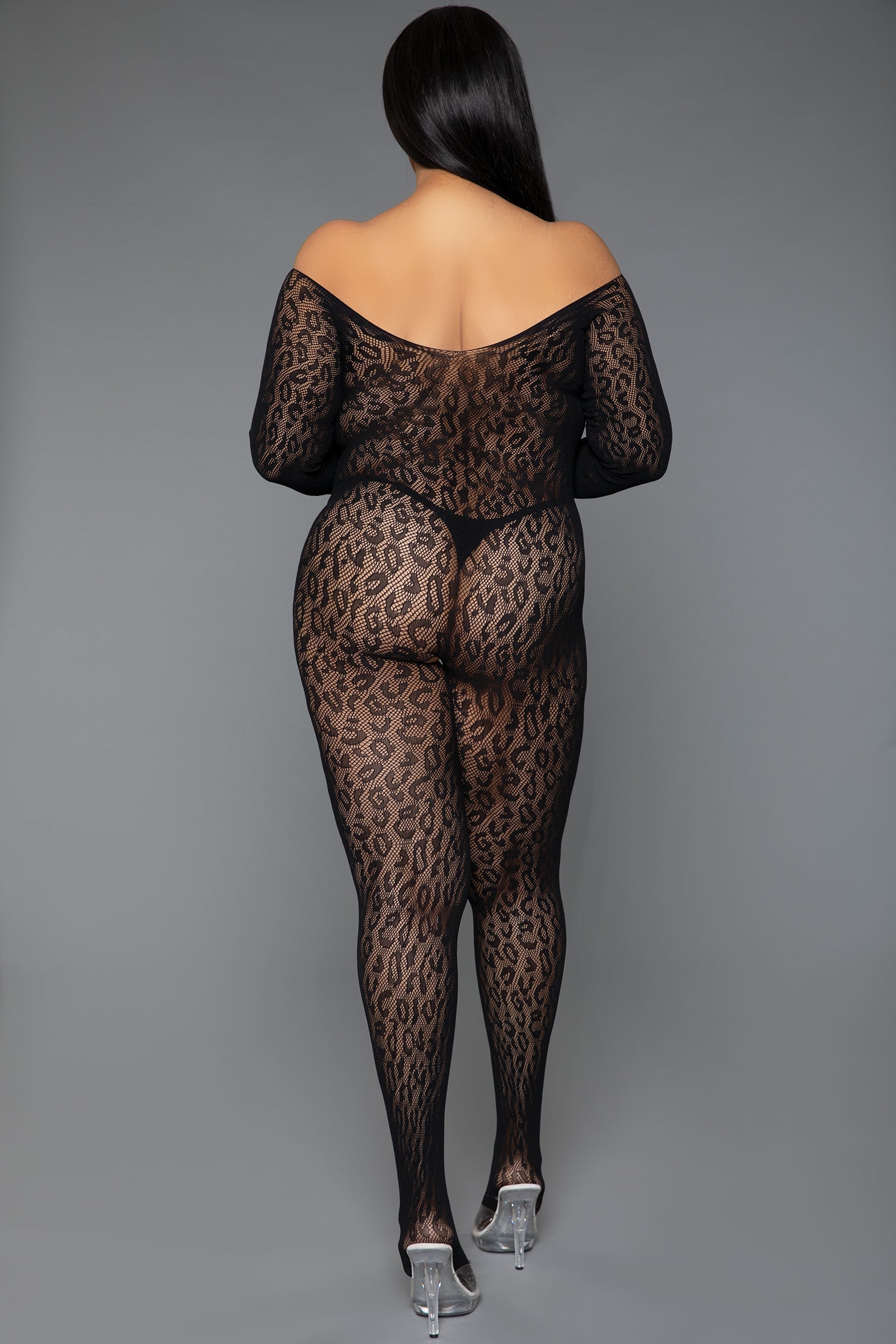 Person wearing a black leopard print bodysuit on a gray background