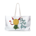 A white weekender bag with a playful pineapple design, featuring text and decorative details on the fabric.
