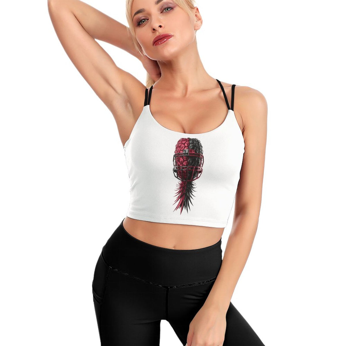 A woman modeling a white crop top with thin black straps and a red and black feather graphic on the front, paired with black leggings, against a plain white background.