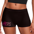 Black athletic shorts with a pink '#HERS' text graphic on the left leg, shown on a model against a white background.