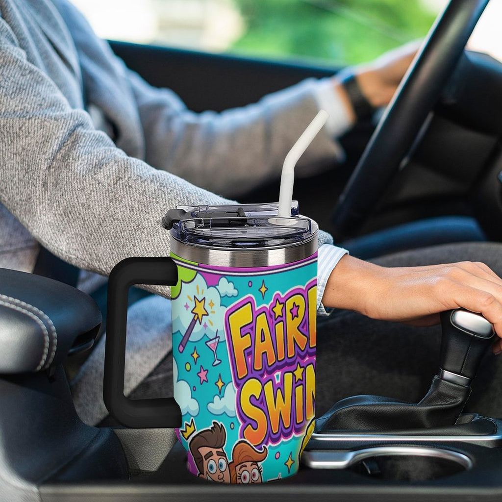 A person driving a car holds a handle on a large insulated tumbler cup. The cup has a colorful cartoon-style graphic with the text 'FAIRY SWIN' and a turquoise background.