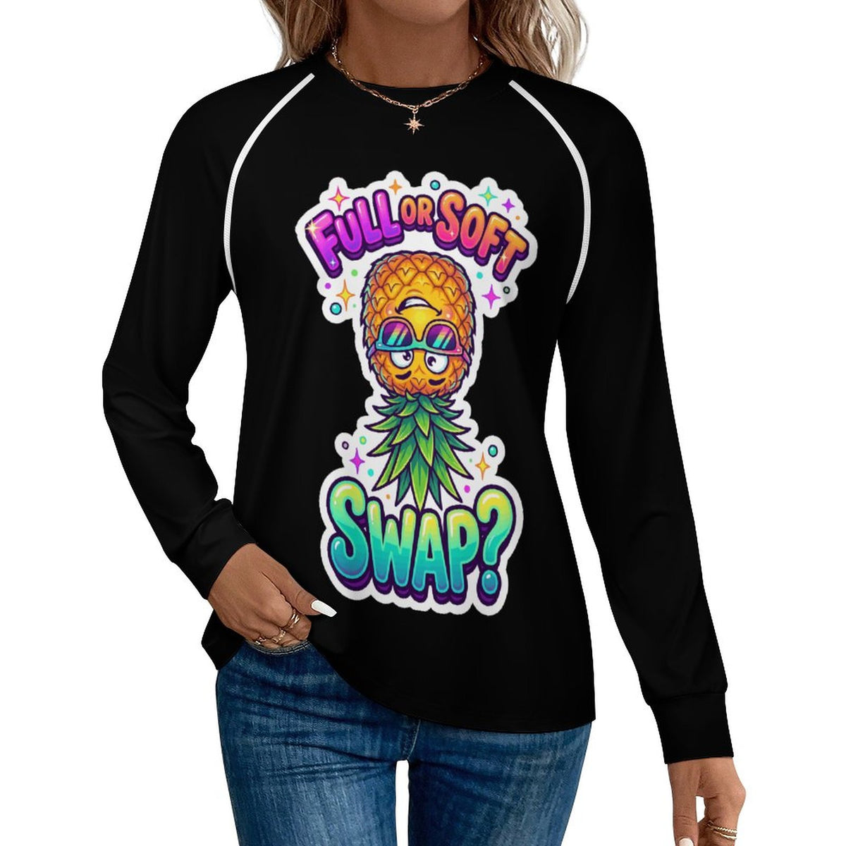 A woman wearing a black long-sleeve raglan t-shirt with a colorful graphic of a pineapple wearing sunglasses and a green leafy collar, with the text 'FULL OR SOFT SWAP?' in a rainbow gradient.