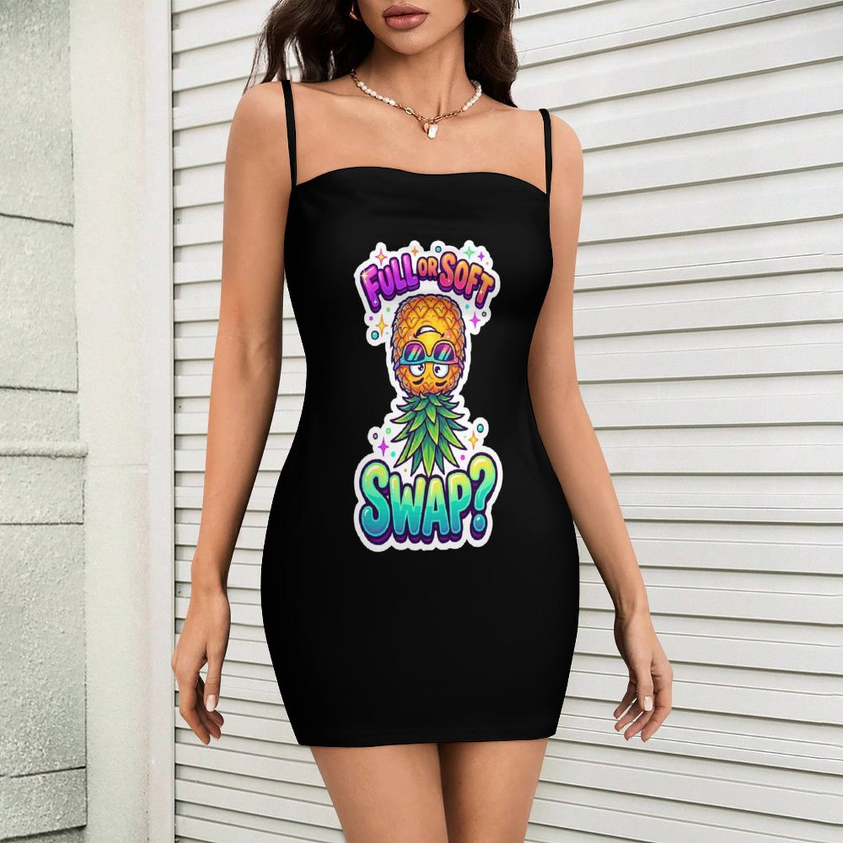 A woman wearing a black spaghetti-strap bodycon mini dress with a colorful pineapple graphic and the text 'FULL SWAP? SWAP?' on the front, standing against a white siding wall.
