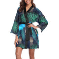 Woman wearing a colorful fern and pineapple kimono with a black belt.