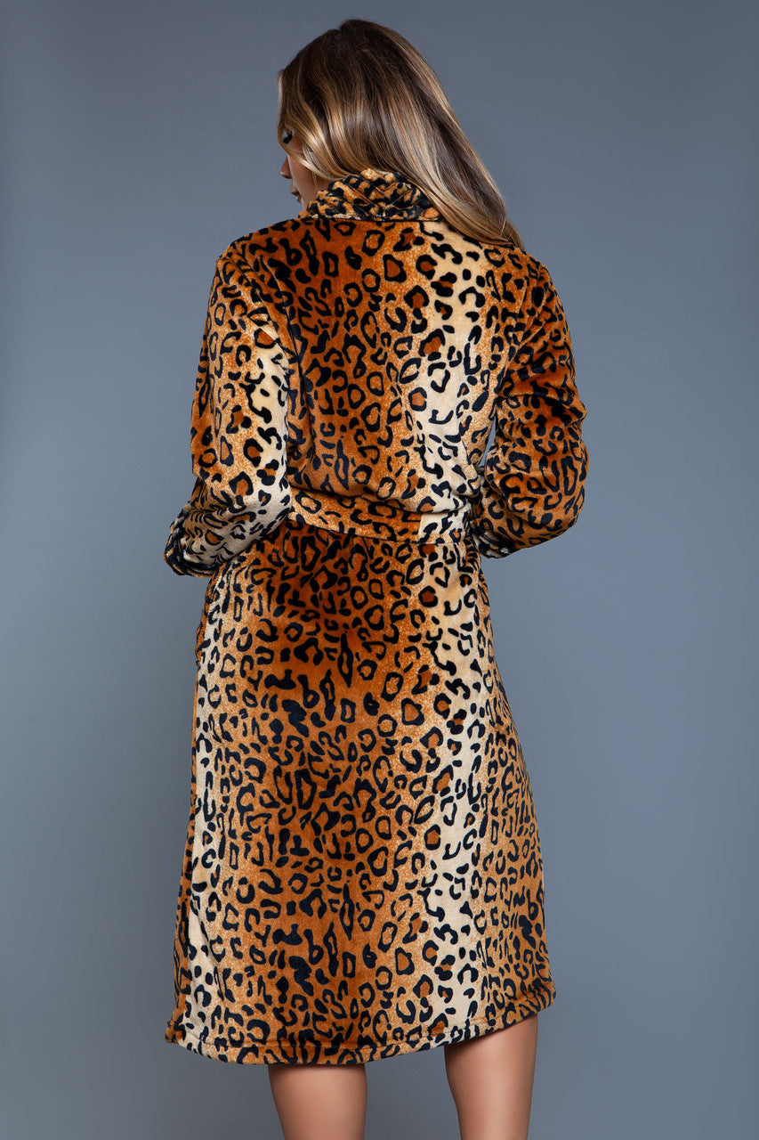 Woman wearing a leopard print dress against a gray background