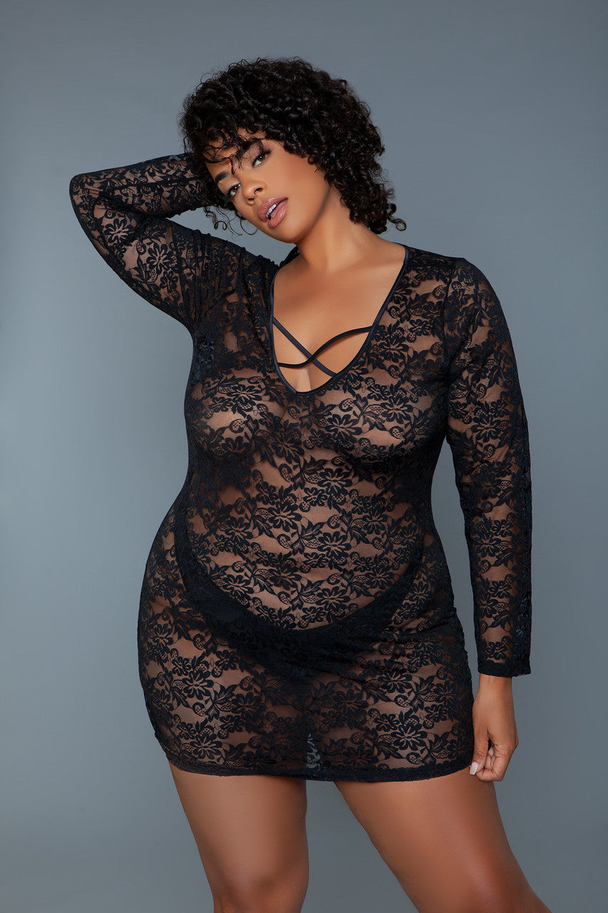 Woman wearing a black lace lingerie set against a gray background