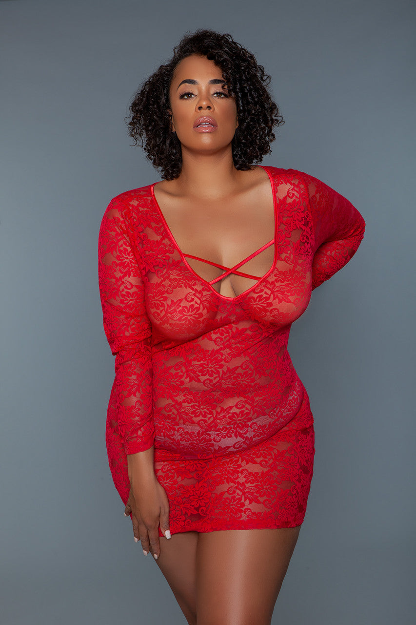 Woman wearing a red lace dress against a gray background