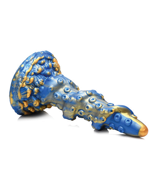 Blue and gold ceramic dragon figurine on a white background