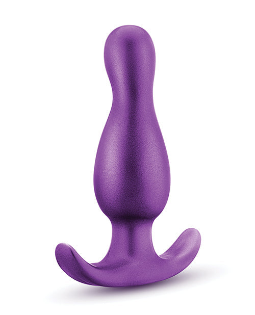 Purple silicone butt plug on a white background