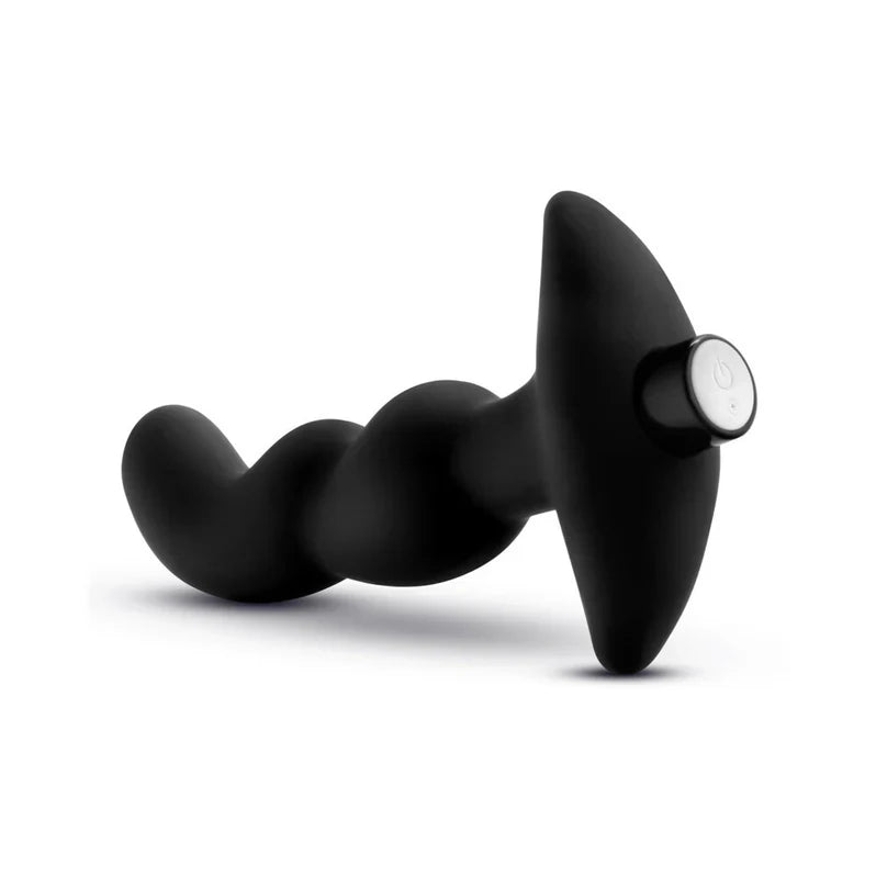 Black handheld massager on a white background