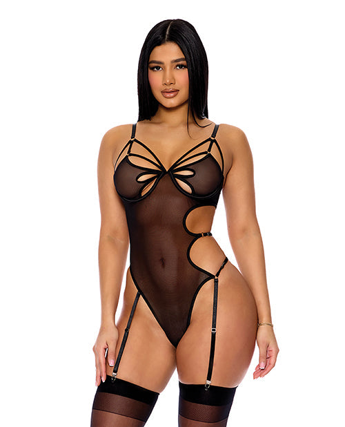 Model wearing a black strappy bodysuit on a white background