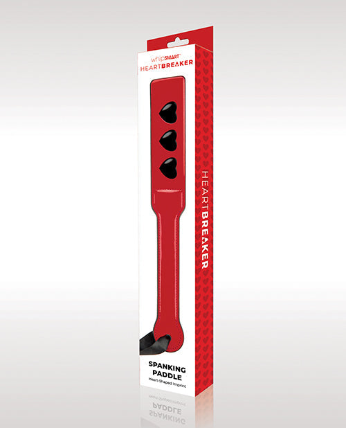 Red.spanking paddle with black hearts in packaging on a white background