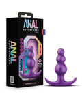 Purple anal plug with packaging labeled 'Anal Adventures' on a white background