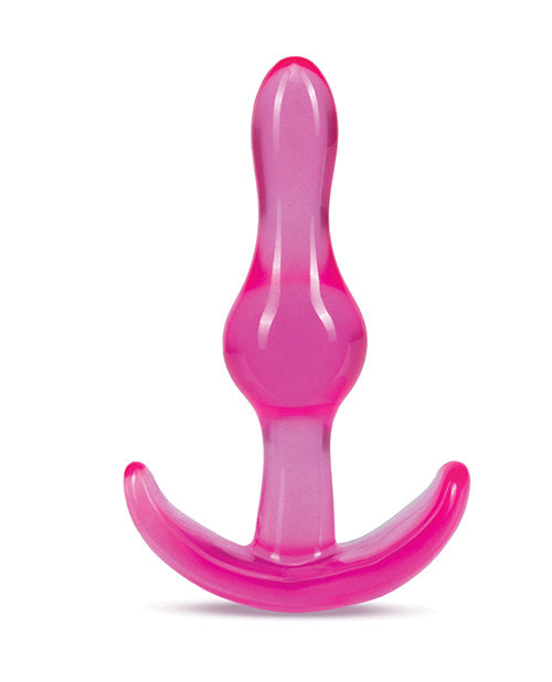 Pink and clear plastic anchor-shaped object on a white background