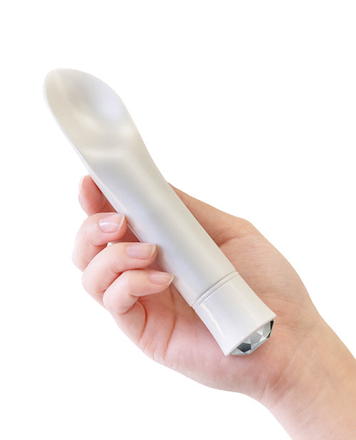 White handheld device held in a hand on a white background