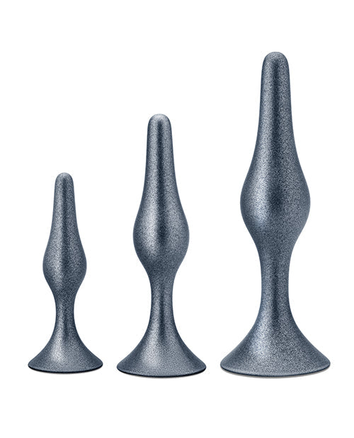 Three metallic gray butt plugs of different sizes on a white background