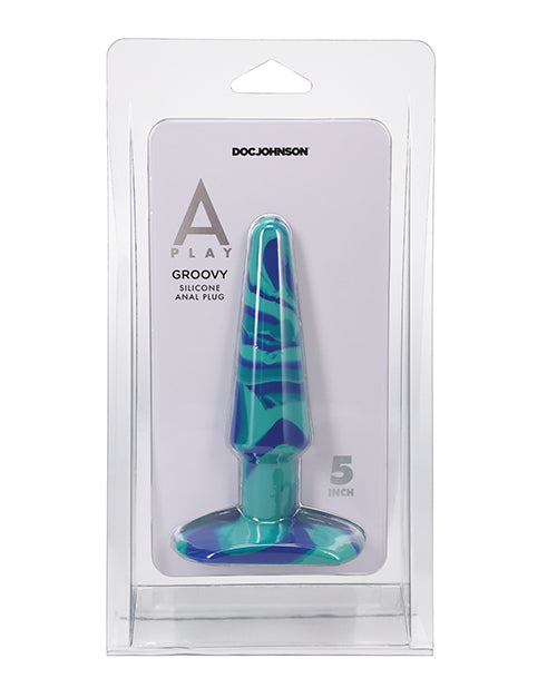 Blue and green anal plug in packaging with 'Doc Johnson' branding on a white background