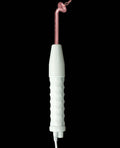Dental tool with a white handle and pink head on a black background