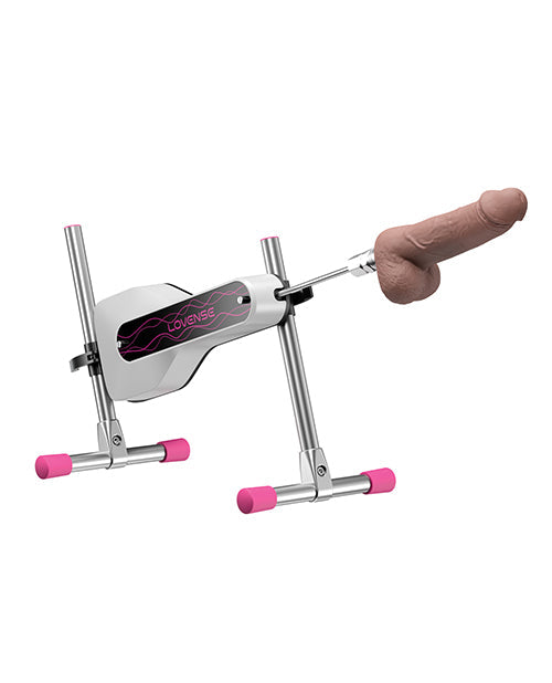 Metallic device with pink accents and a brown object on a white background
