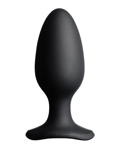 Black silicone butt plug on a white background