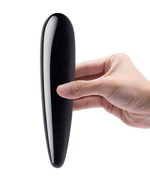 Hand holding a black and silver cylindrical object against a white background