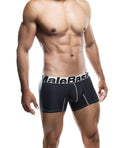 Man wearing black boxer briefs with 'MaleBasic' waistband on a white background