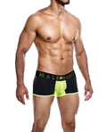 Man wearing black and green underwear with 'Male Basics' brand logo on a white background