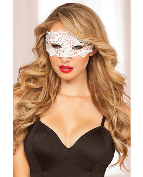 Woman wearing a white lace eye mask with a plain background