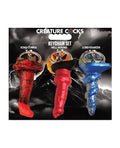 Packaged keychain set of 'Creature Cocks' with three different designs on a dark background.
