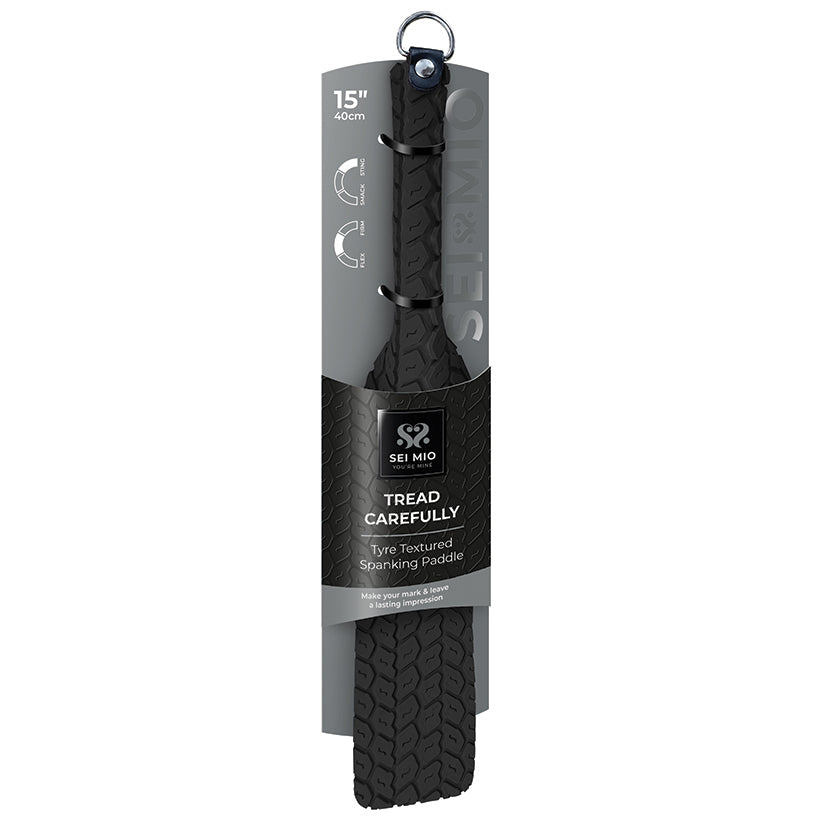Black standing paddle with textured surface and packaging on a white background