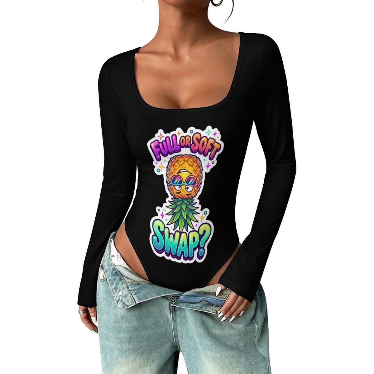 A woman wearing a black long-sleeve bodysuit with a colorful pineapple graphic and the text 'FULL SOFT SWAP?' on the front, paired with light-wash denim jeans against a plain white background.