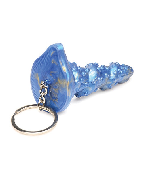 Blue shoe-shaped keychain with gold accents on a white background
