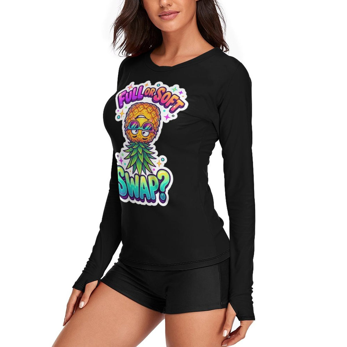 A woman wearing a black long-sleeve t-shirt with a colorful graphic print of a pineapple wearing sunglasses and the text 'FULL OR SOFT SWAP?'.