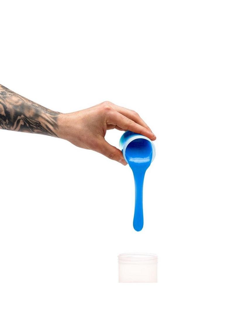 Hand holding a blue plastic scoop against a white background