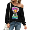 A woman wearing a black off-the-shoulder sweatshirt with a colorful pineapple graphic and the text 'FULL OR SOFT SWAP?' paired with blue jeans and a white shoulder bag.