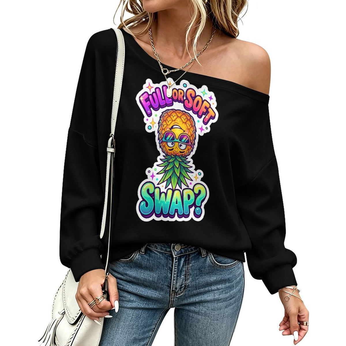 A woman wearing a black off-the-shoulder sweatshirt with a colorful pineapple graphic and the text 'FULL OR SOFT SWAP?' paired with blue jeans and a white shoulder bag.