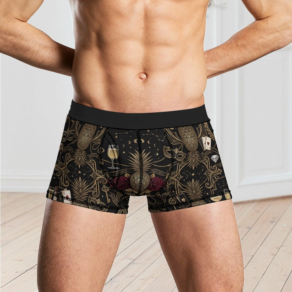 Man standing in a room wearing pineapple themed boxers with shirt off