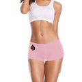 Woman wearing a pink pair of boyshorts with a "QOS" on the upper Right side on the upper right side of the shorts with a white sports bra on.