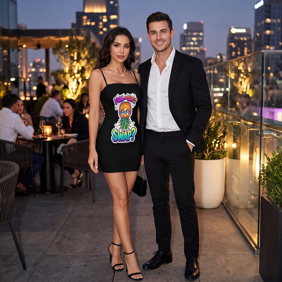 Couple posing at an upscale rooftop lounge at dusk, with a woman wearing a black mini dress featuring a colorful pineapple graphic and ‘Full or Soft Swap?’ lettering beside a man in a black suit.