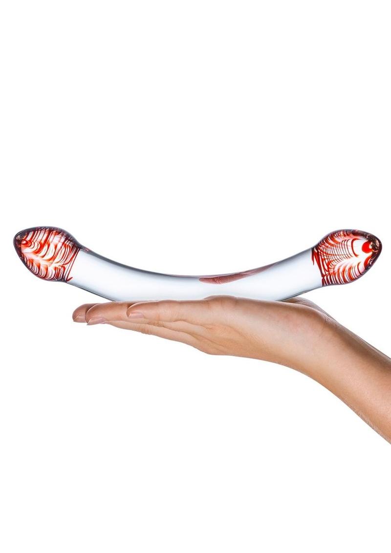 White and red object held in a hand on a white background
