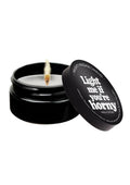 Black candle jar with a lit wick and 'Light me if you're horny' text on a white background