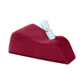 Red wedge pillow with a white and gold object on a white background