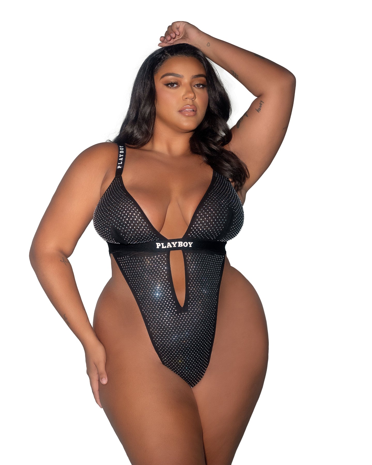 Model wearing a black mesh Playboy bodysuit on a white background